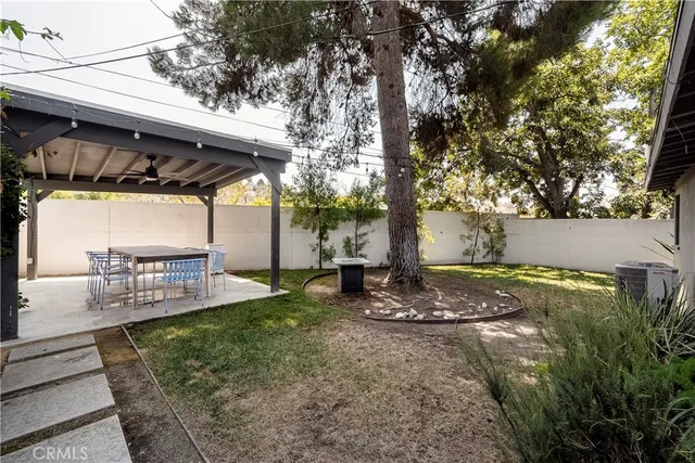 a view of a backyard with plants and a patio
