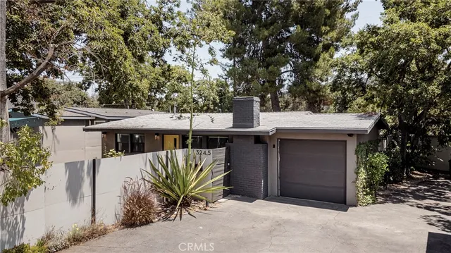 a view of a house with a tree beside it