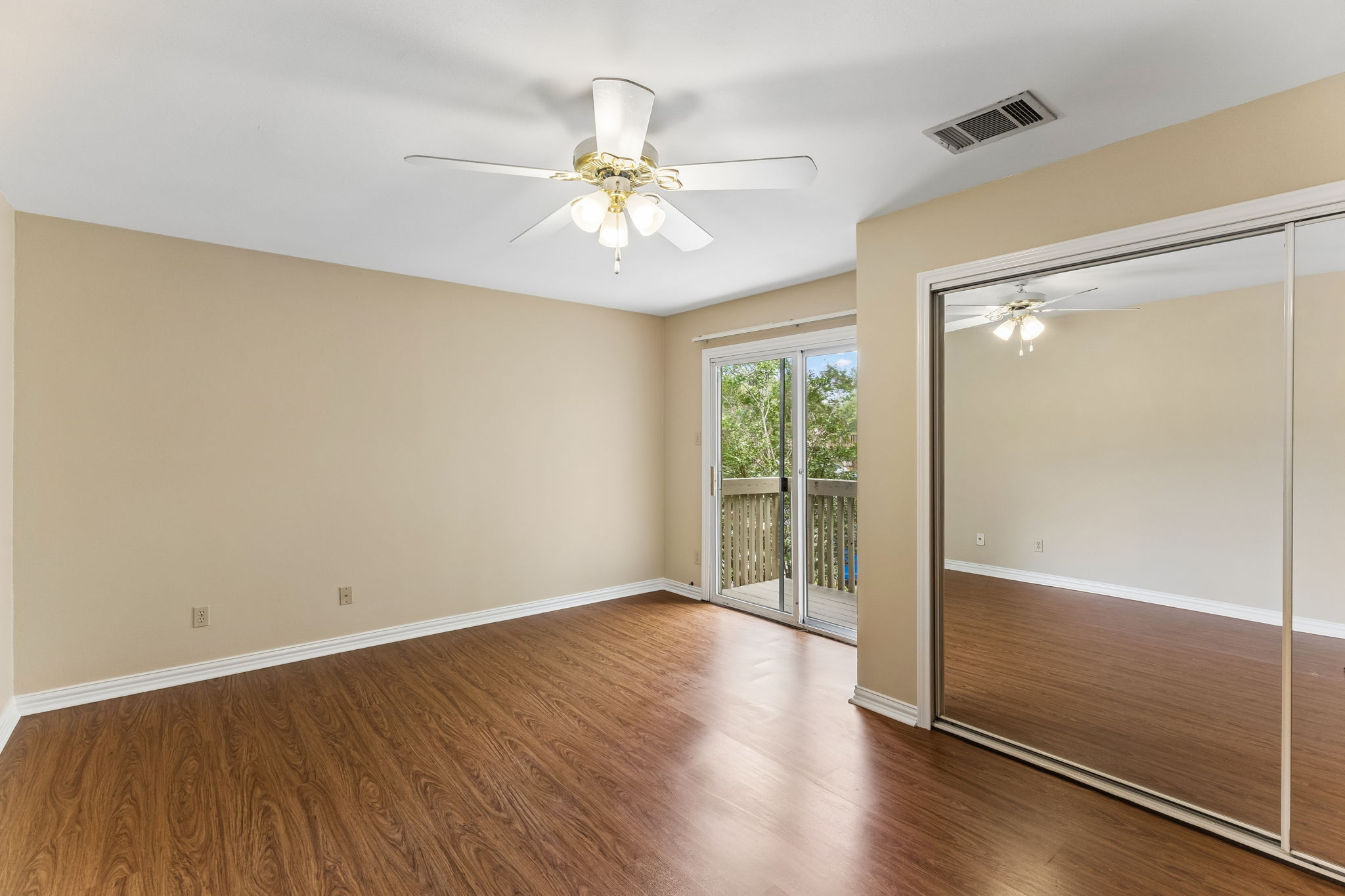 8340 Fathom Circle, Unit 103 Austin, TX 78750 - Photo 29 of 30 an empty room with wooden floor fan and windows