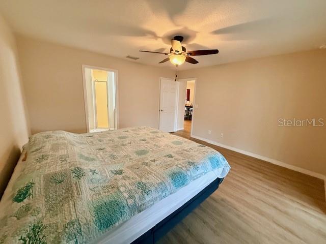 1026 Southeast 65th Circle Ocala, FL 34472 - Photo 18 of 29 a bedroom with a bed and a chandelier