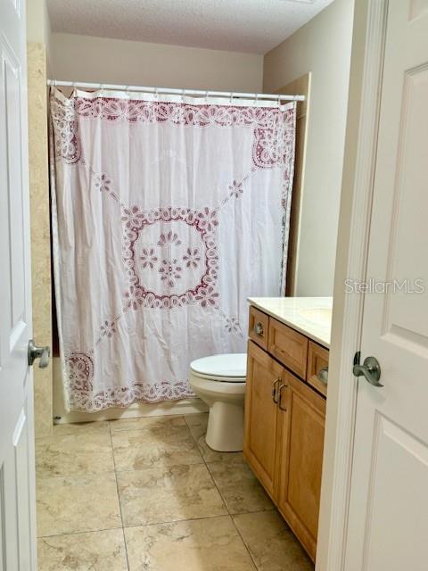 1026 Southeast 65th Circle Ocala, FL 34472 - Photo 20 of 29 a bathroom with a toilet sink and shower curtain