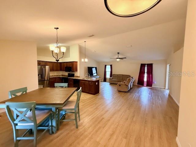1026 Southeast 65th Circle Ocala, FL 34472 - Photo 2 of 29 a view of a dining room with furniture and wooden floor