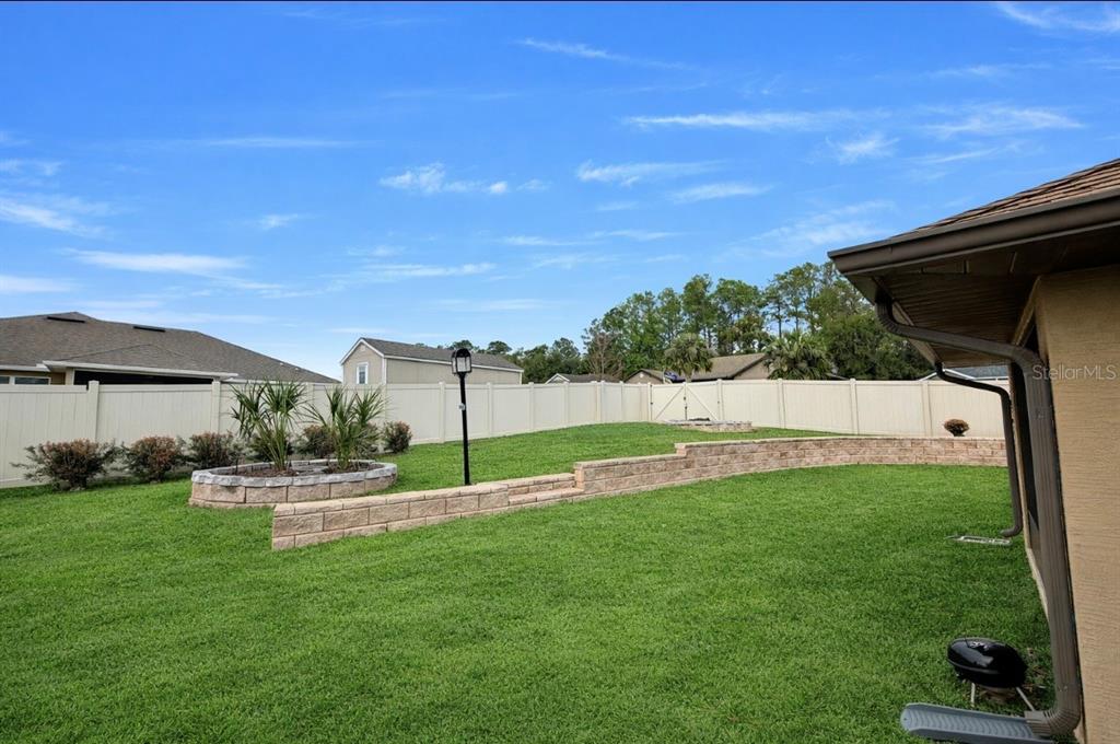 1026 Southeast 65th Circle Ocala, FL 34472 - Photo 25 of 29 a view of garden with patio