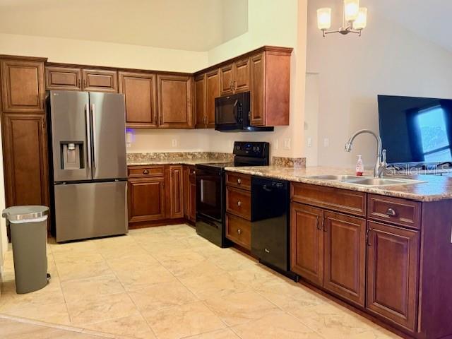 1026 Southeast 65th Circle Ocala, FL 34472 - Photo 7 of 29 a kitchen with stainless steel appliances granite countertop a refrigerator a stove top oven and sink