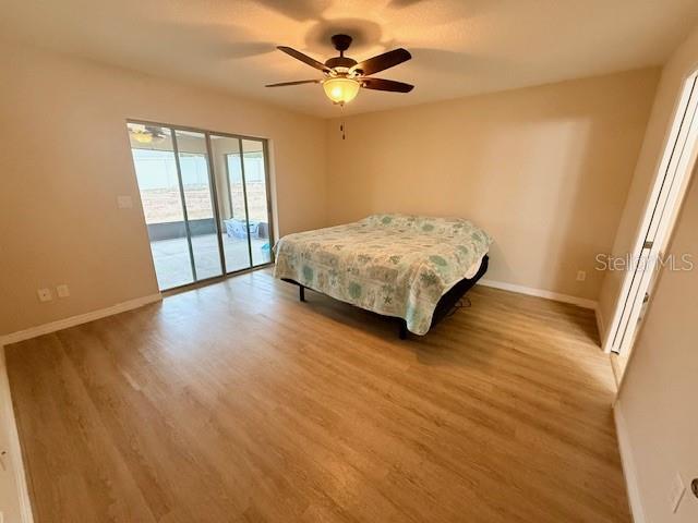 1026 Southeast 65th Circle Ocala, FL 34472 - Photo 10 of 29 a bedroom with a bed and a ceiling fan