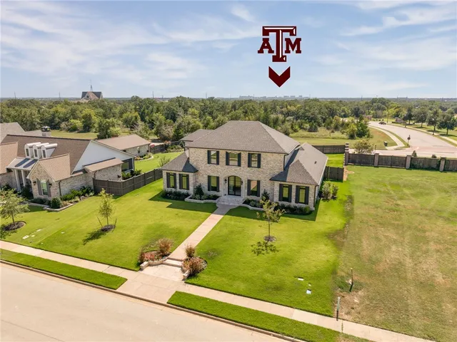 an aerial view of residential houses with outdoor space and swimming pool