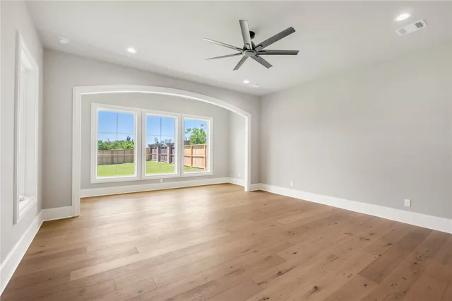 a bedroom with a bed a couch and potted plant