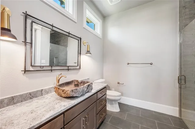 an aerial view of a house with swimming pool and large trees