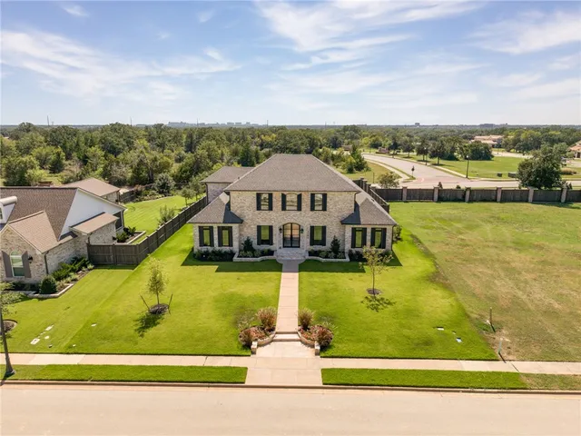 an aerial view of a house with a big yard