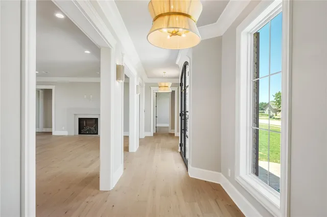 a view of an empty room with a kitchen and window