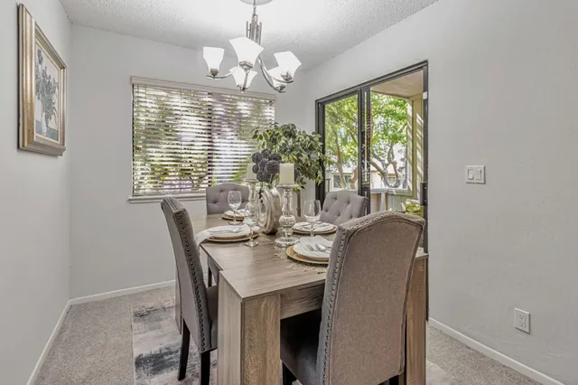a view of a dining room with furniture wooden floor and chandelier