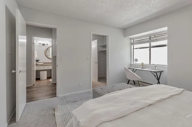 a bedroom with a bed and a window