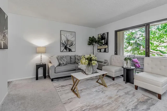 a living room with furniture and a large window