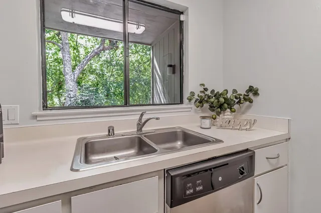 a view with a sink and mirror