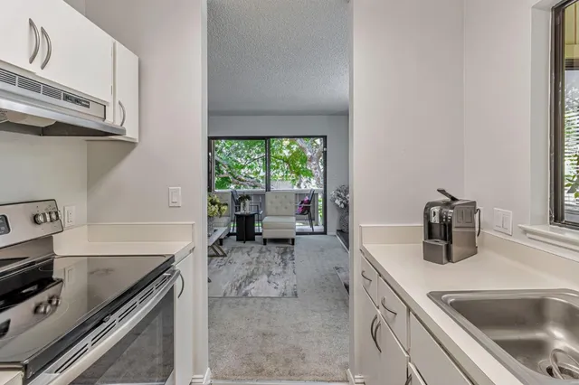 a kitchen with a sink stove and cabinets