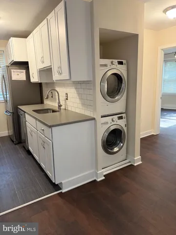 a kitchen with stainless steel appliances granite countertop a sink a stove and cabinets