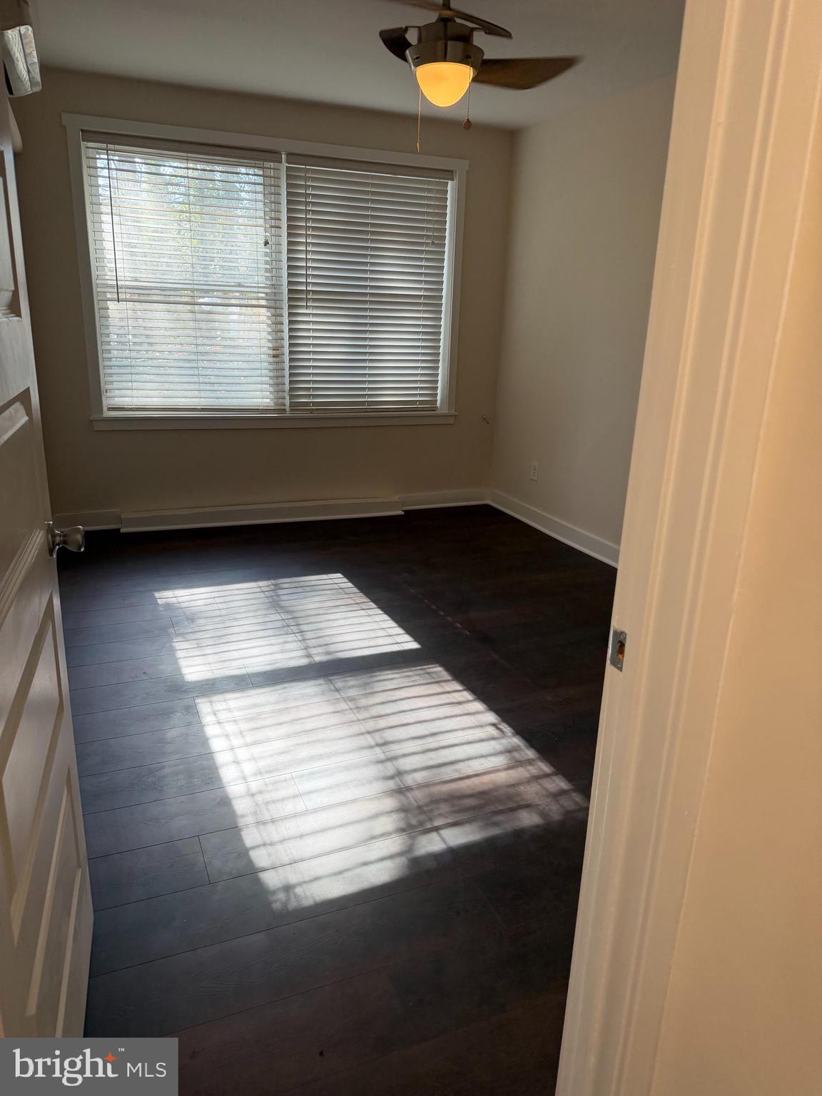 514 Ridge Road Southeast, Unit 111 Washington, DC 20019 - Photo 8 of 9 a view of wooden floor and windows in a room