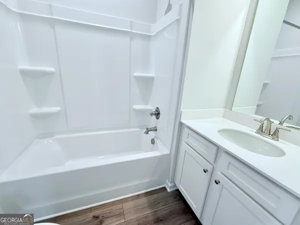 a bathroom with a bathtub and a sink