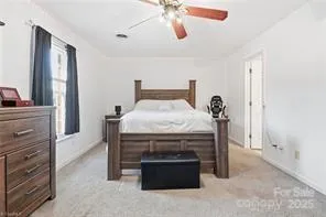 a bed sitting in a room next to a window