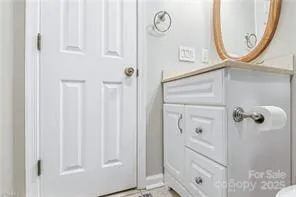 a bathroom with a sink a toilet and a mirror