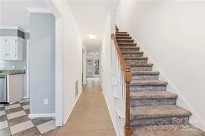 a view of a hallway with wooden floor and entryway