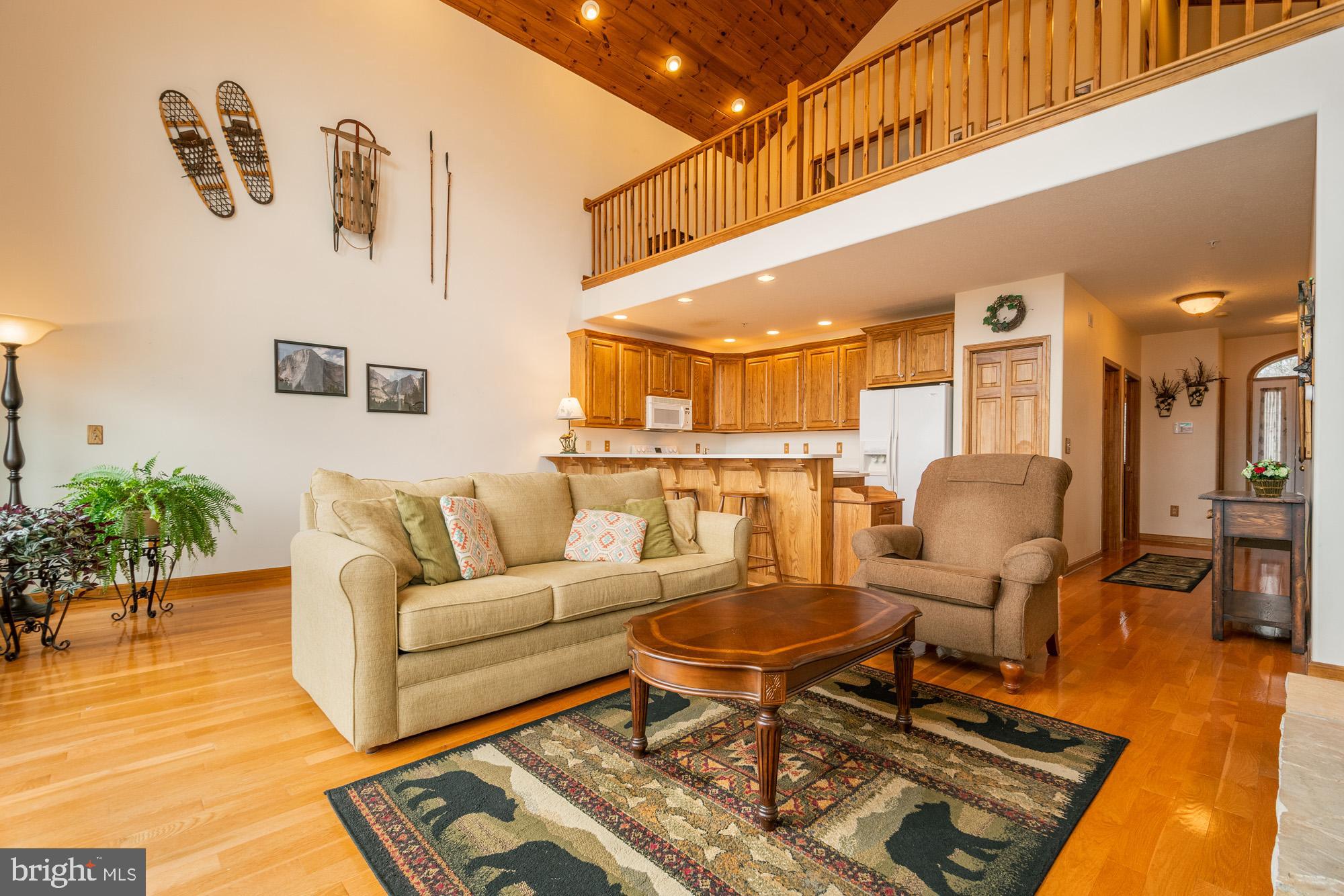 750 Wisp Mountain Road, Unit B McHenry, MD 21541 - Photo 11 of 49 a living room with furniture and a table