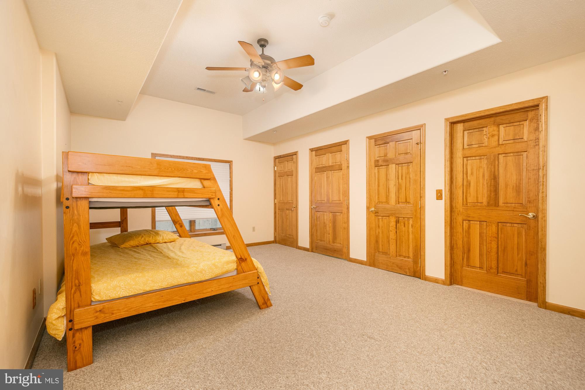 750 Wisp Mountain Road, Unit B McHenry, MD 21541 - Photo 18 of 49 a bed room with a bed and a chandelier