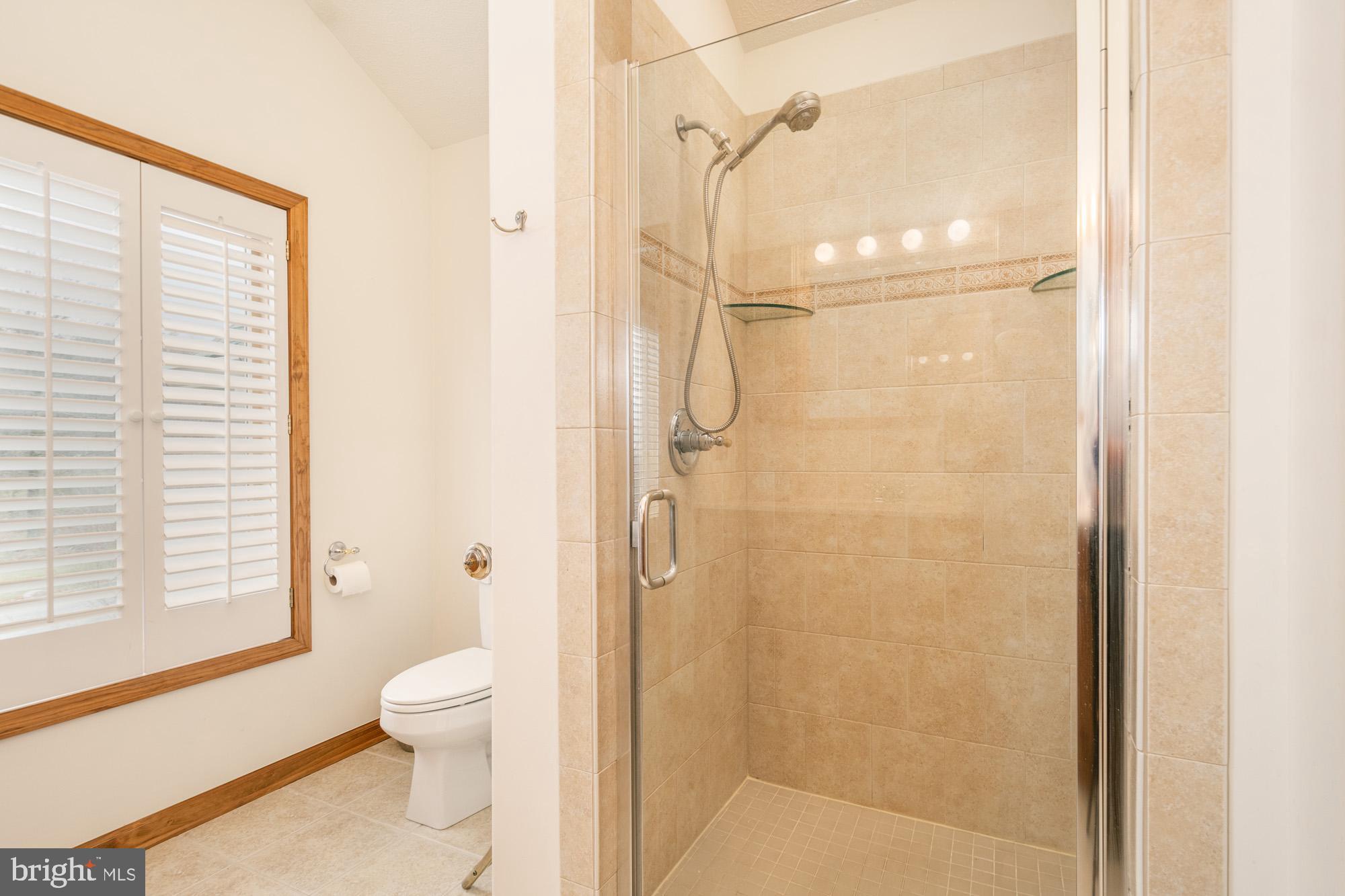 750 Wisp Mountain Road, Unit B McHenry, MD 21541 - Photo 30 of 49 a bathroom with a shower a toilet and a window