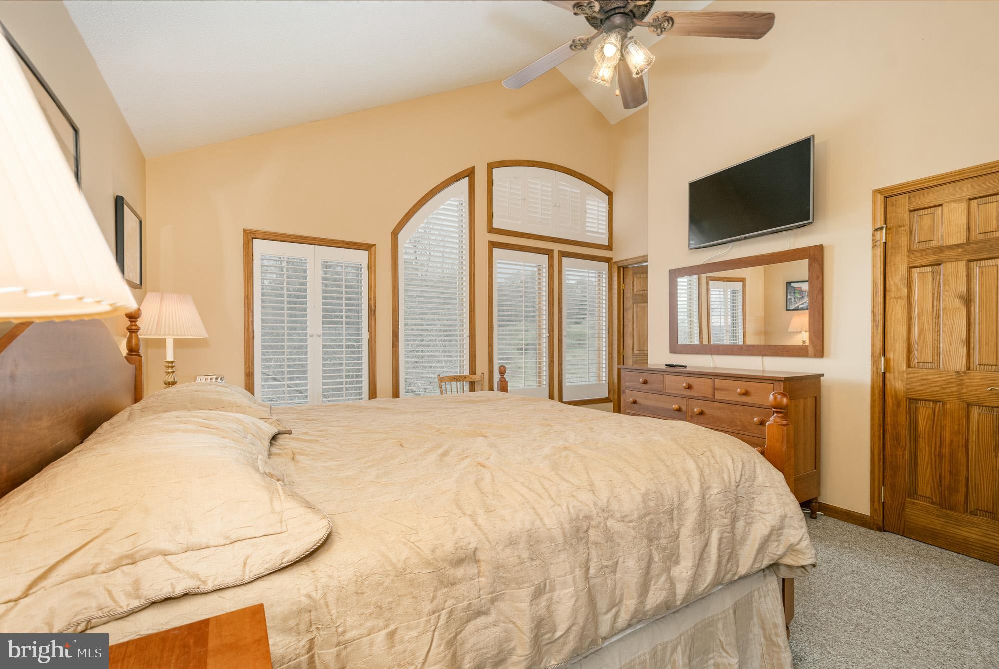 750 Wisp Mountain Road, Unit B McHenry, MD 21541 - Photo 33 of 49 a bedroom with a large bed and a chandelier