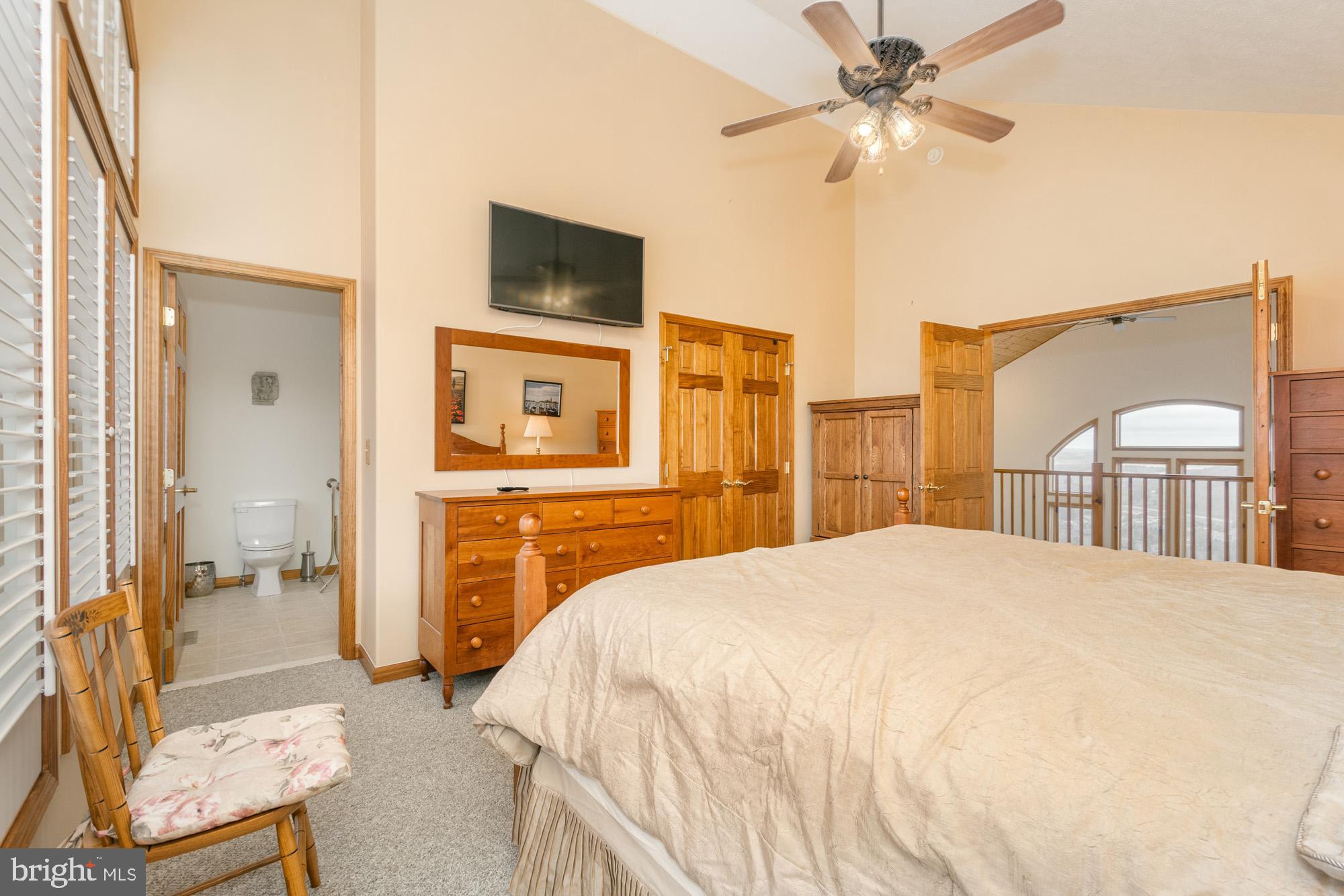 750 Wisp Mountain Road, Unit B McHenry, MD 21541 - Photo 34 of 49 a bedroom with a bed and a chandelier