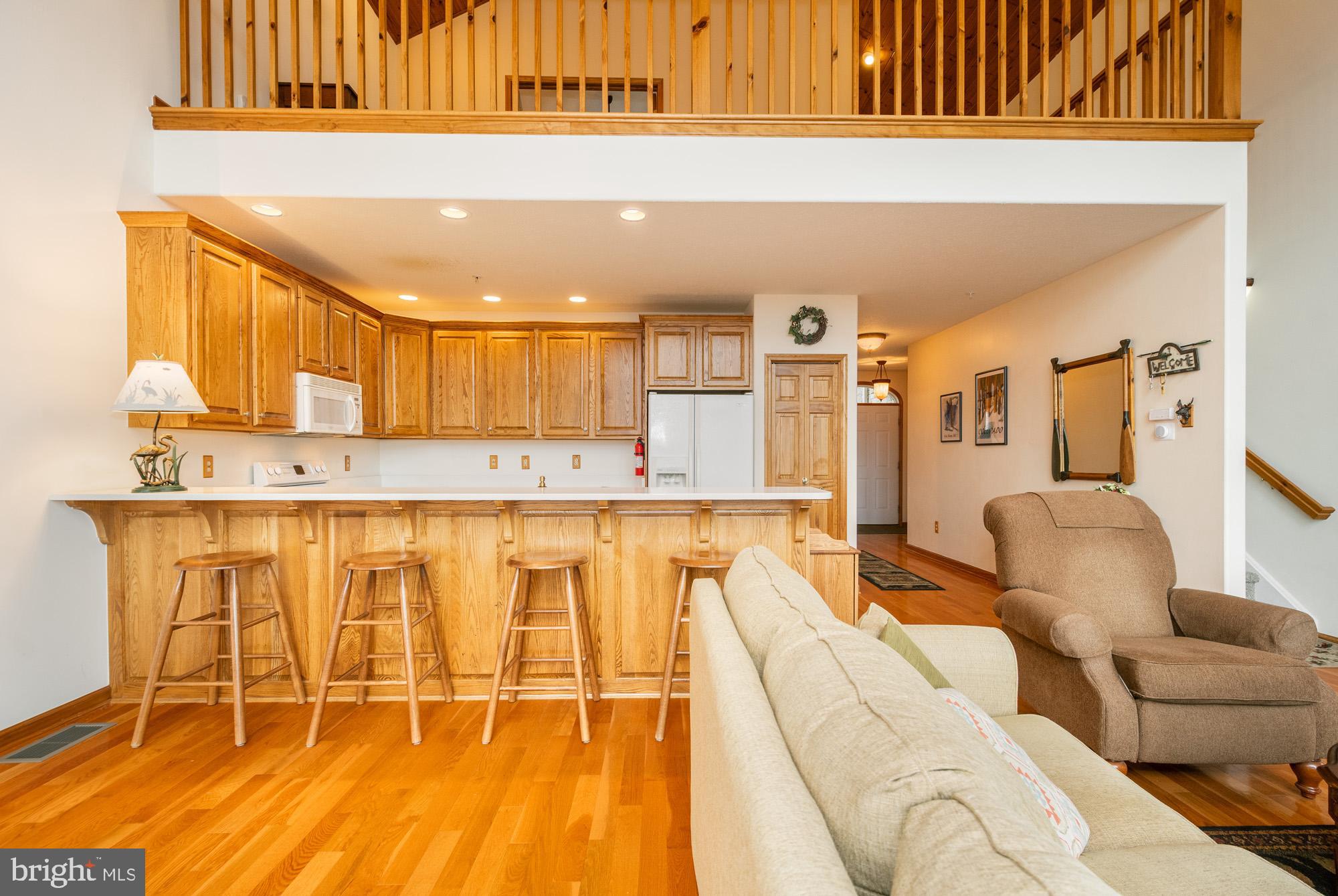 750 Wisp Mountain Road, Unit B McHenry, MD 21541 - Photo 5 of 49 a living room with stainless steel appliances granite countertop a couch and cabinets