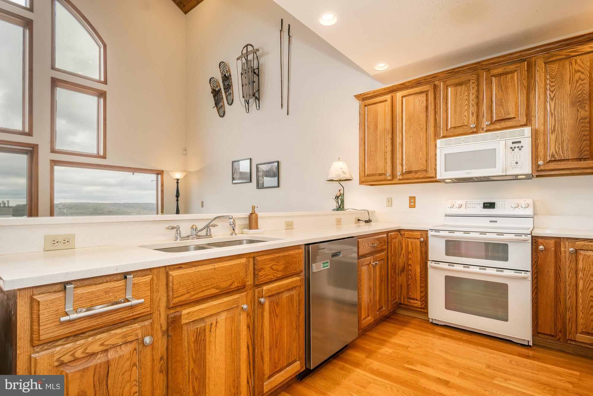 750 Wisp Mountain Road, Unit B McHenry, MD 21541 - Photo 7 of 49 a kitchen with cabinets appliances a sink and a window