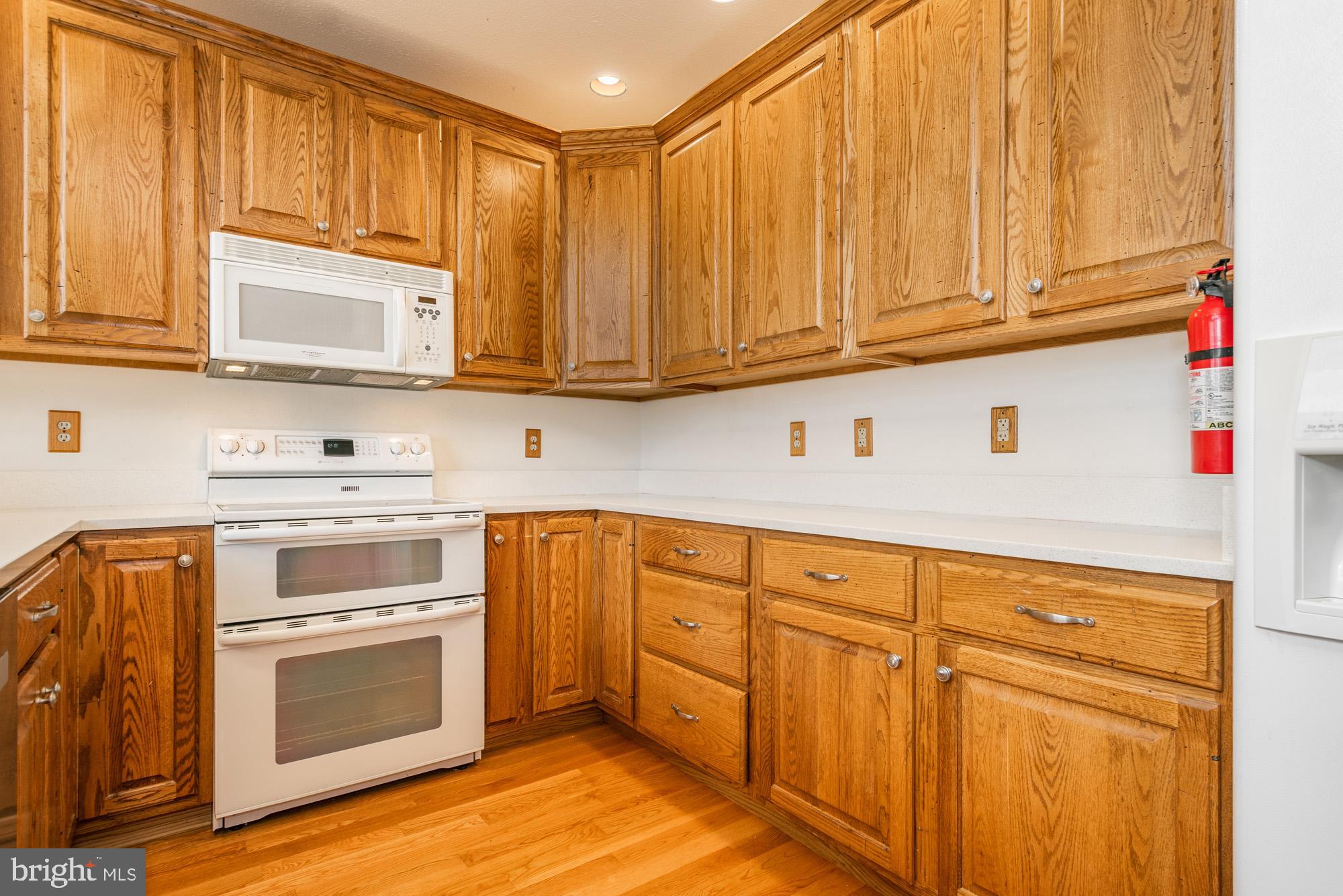 750 Wisp Mountain Road, Unit B McHenry, MD 21541 - Photo 8 of 49 a kitchen with stainless steel appliances granite countertop wooden cabinets a sink and dishwasher with wooden floor