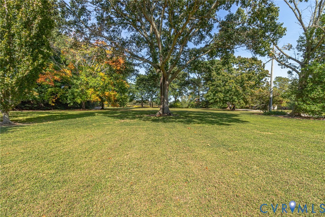 430 Harveys Neck Road Heathsville, VA 22473 - Photo 13 of 51 Expansive lawn area featuring mature trees adds to