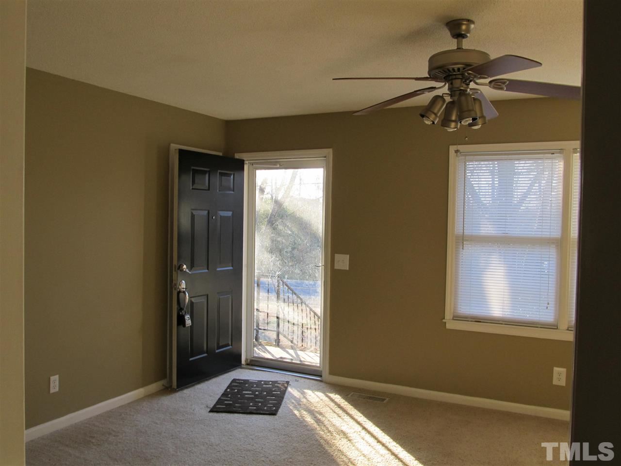 512 Old Stage Road North Coats, NC 27521 - Photo 14 of 18 a bedroom with a bed and a chandelier