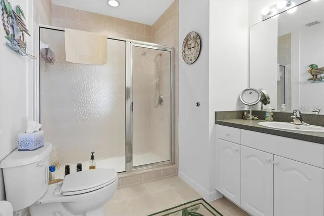 a bathroom with a granite countertop sink a mirror and a shower