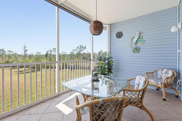 a view of a balcony dining area with furniture