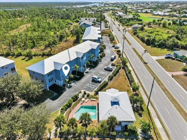 an aerial view of a house with a yard