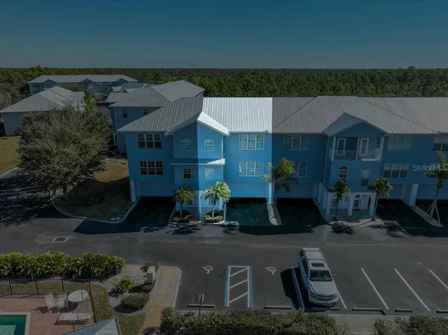 an aerial view of a house with swimming pool and garden