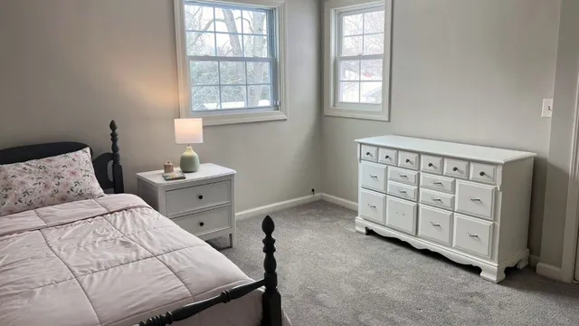 a view of an empty room with a fireplace and a window