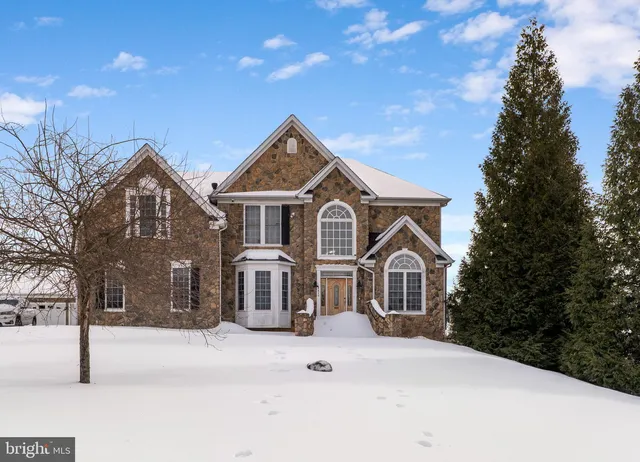 a very nice looking living room with stainless steel appliances furniture a flat screen tv and a kitchen view