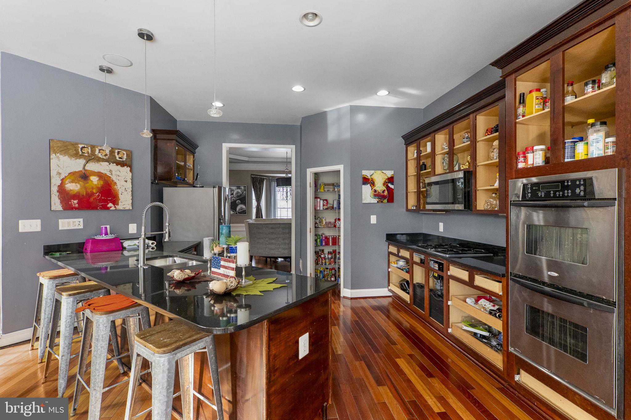 8400 Summit Avenue Baltimore, MD 21244 - Photo 16 of 55 a kitchen with stainless steel appliances granite countertop a stove refrigerator and a dining table
