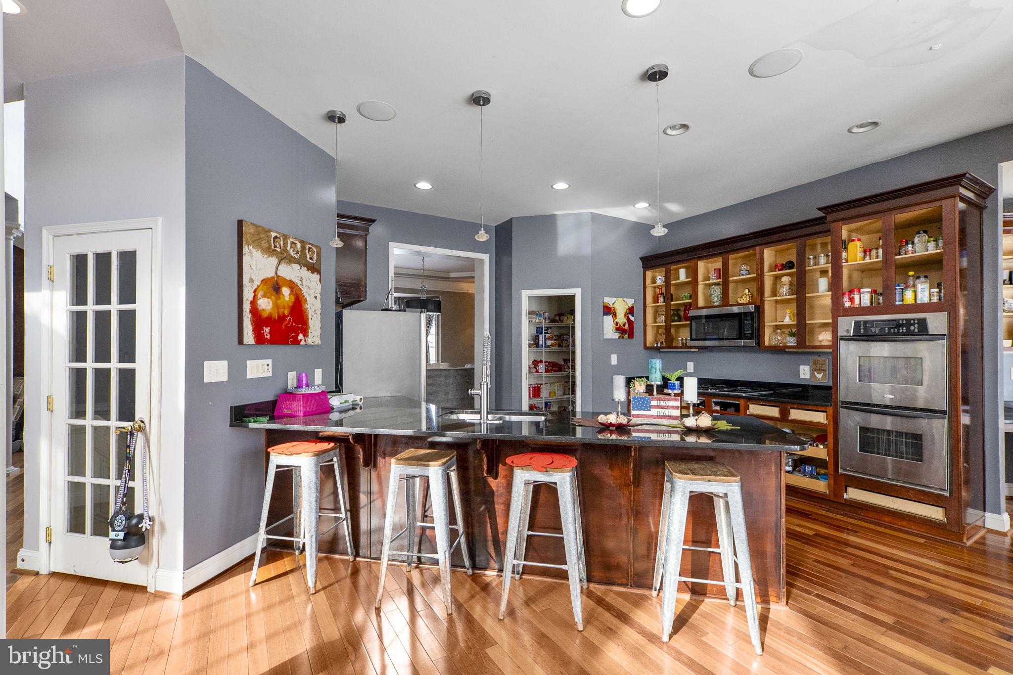 8400 Summit Avenue Baltimore, MD 21244 - Photo 18 of 55 a kitchen with stainless steel appliances granite countertop a stove and cabinets