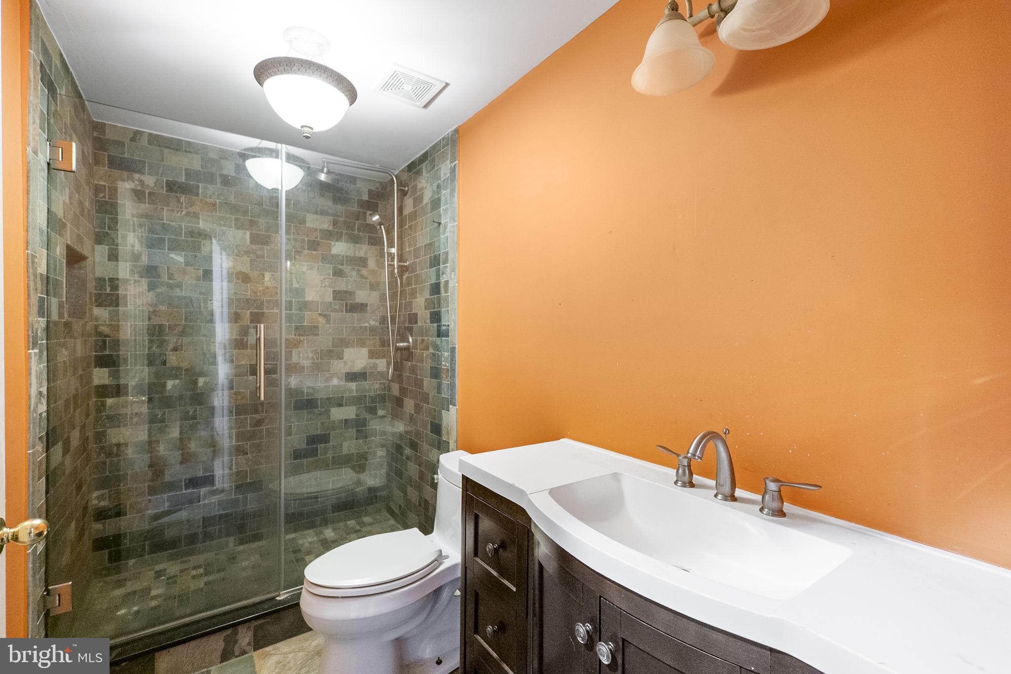 8400 Summit Avenue Baltimore, MD 21244 - Photo 36 of 55 a bathroom with a sink mirror toilet and shower