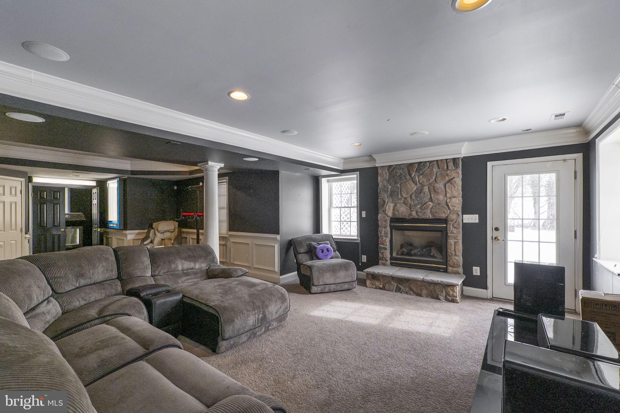 8400 Summit Avenue Baltimore, MD 21244 - Photo 39 of 55 a living room with furniture a flat screen tv and a fireplace