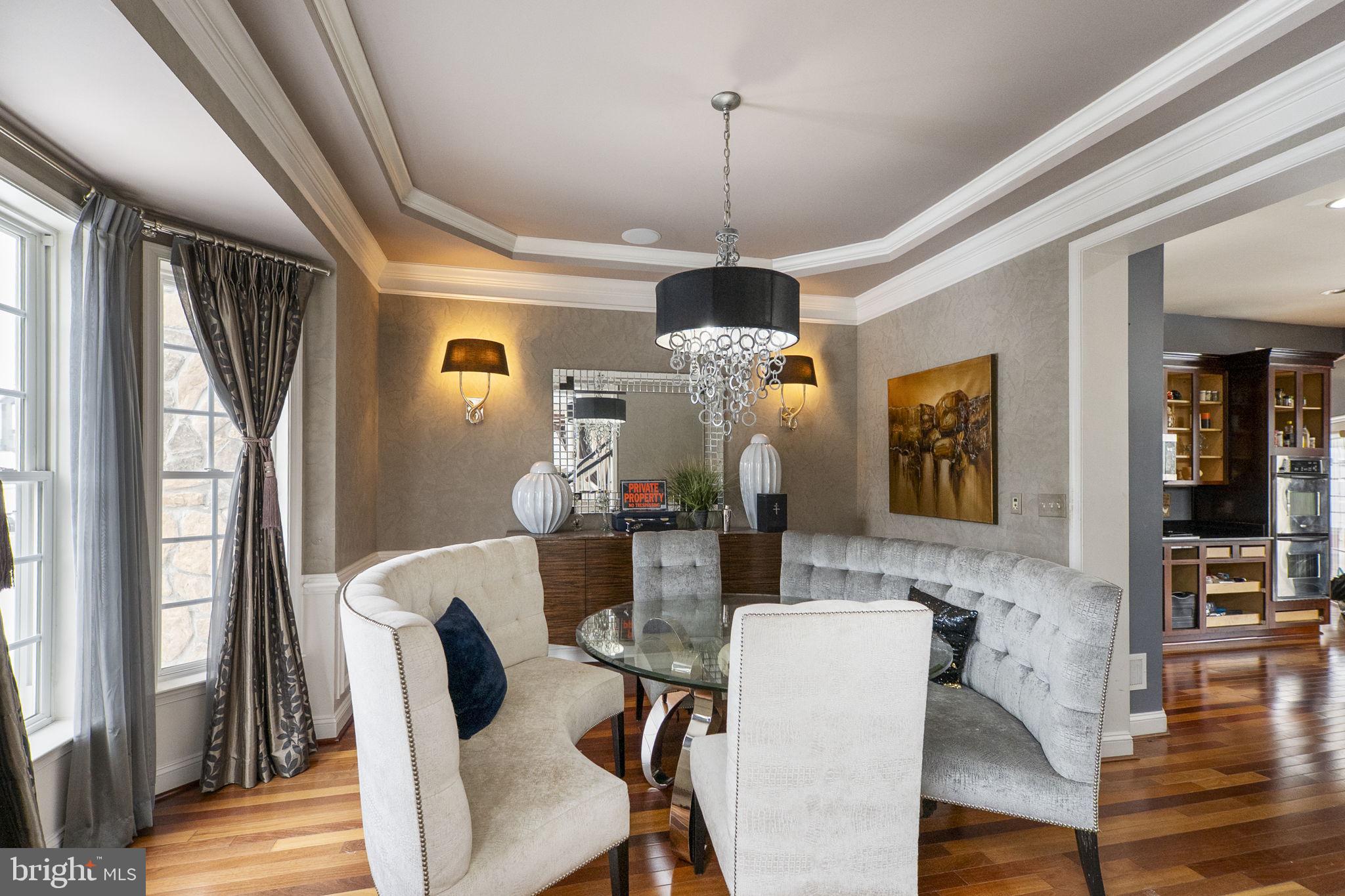 8400 Summit Avenue Baltimore, MD 21244 - Photo 6 of 55 a dining room with furniture a chandelier and wooden floor
