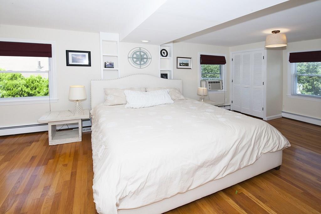 49 Moffatt Road Salem, MA 01970 - Photo 14 of 25 a spacious bedroom with a bed and a wooden floor