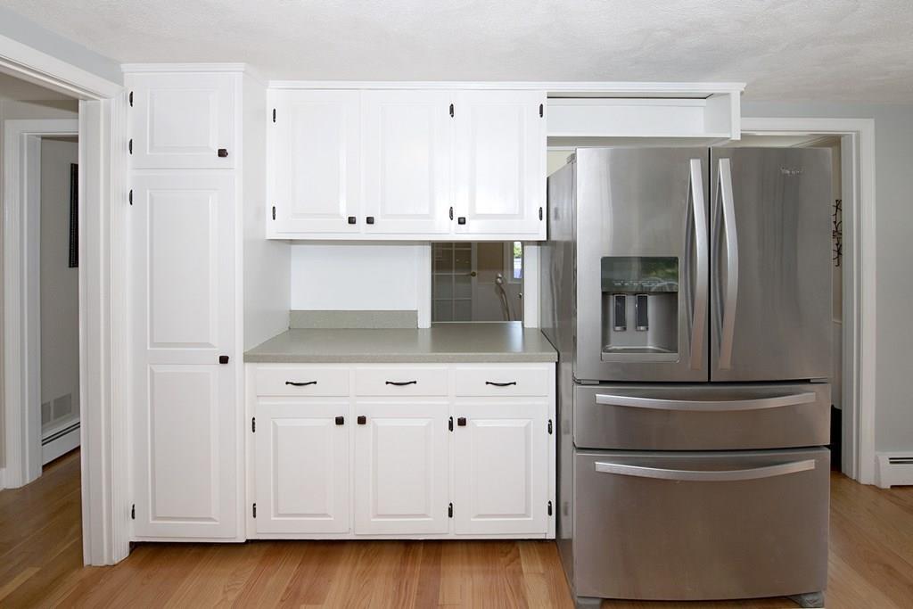 49 Moffatt Road Salem, MA 01970 - Photo 6 of 25 a kitchen with stainless steel appliances a refrigerator and a cabinets