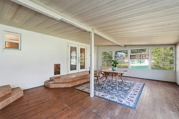 a view of a door and wooden floor