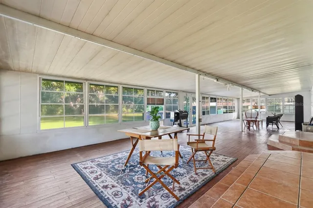 a backyard of a house with lots of green space and outdoor seating